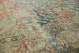 Distressed vintage Heriz carpet texture with faded indigo blue, cherry red, and ivory tones.