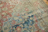 Distressed floral patterns in faded blue, red, and ivory with visible texture.