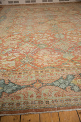 Distressed Persian Mahal carpet border showing worn floral vinery in terra cotta and soft blues.