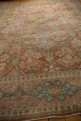 Distressed Mahal carpet's worn field texture, floral border, and visible knot heads.