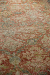 Distressed Mahal carpet pile showcasing softened floral pattern with muted terra cotta and green tones.