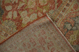 Mahal carpet corner reveals hand-knotted foundation, terra cotta side cord, distressed floral pattern.