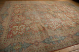 Distressed Mahal carpet, soft terra cotta, sky blue, and green floral vinery with mostly even wear.