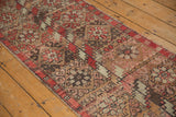 Paneled floral geometric design with zig-zag motifs in deep red, blush, and brown tones.