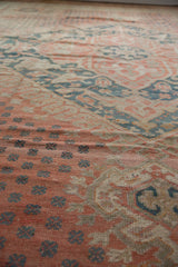 Distressed Vintage Oushak carpet with softened pale ruby red, sand, and dusty teal motifs.