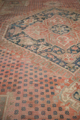 Distressed vintage Oushak carpet pile in soft blush, dusty teal, and sand tones.