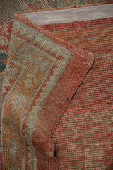 Oushak rug detail: distressed soft-toned pile, corded selvage, and hand-knotted reverse.