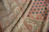 Distressed vintage Oushak rug texture with muted beige, dusty red, and subtle teal motifs.