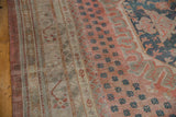 Distressed Oushak with even wear showing pale blush, dusty teal, and sand tones.