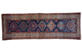 Vintage Northwest Persian runner with repeating geometric medallions, navy blue, madder red, ivory tones.