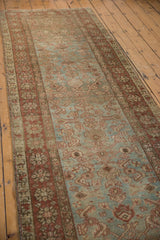 Distressed Heriz runner's abrashed sky blue ground and worn chestnut Herati motif.