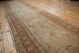 Distressed Heriz runner showing Herati motif on abrashed pale ocean green with even pile wear.