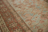 Close-up of vintage distressed Heriz runner showing Herati motif, soft blues, blush, and even wear.