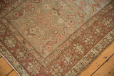 Distressed pile of vintage Heriz runner, abrashed green field with dusty blush Herati motif.
