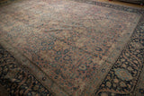 Low-pile texture of a vintage Tabriz carpet with an intricate floral design in blush and denim blue.