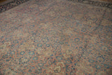 Detailed view of the time-softened pile and intricate weave on a vintage Persian Tabriz carpet.