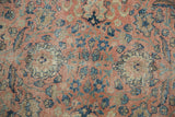 Evenly worn knot heads and intricate floral patterns on a distressed vintage Persian carpet.