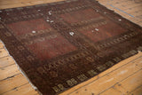 Antique Turkmen carpet fragment: wine red field, geometric starburst guls, and rams horn border.