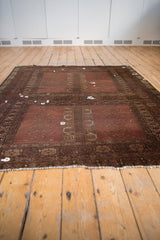 Antique Turkmen carpet features double paneled design in wine red, framed by distinct gul motifs.
