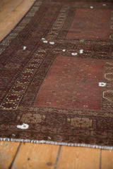 Antique Turkmen carpet featuring starburst gul and rams horn border motifs.