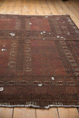 Antique Turkmen carpet’s rams horn border, muted plant motifs, and ivory fringe.