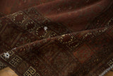 Antique Turkmen fragment: geometric border, deep wine red, and visible hand repair.