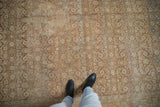 Low, evenly worn pile of a distressed Tabriz carpet revealing a sandy-toned, abrashed Herati design.