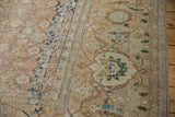 Worn, low pile of a vintage Tabriz carpet showing its samovar border and Herati field.
