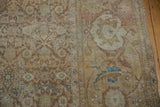 Even wear on a distressed Tabriz rug, showing the low pile and sandy Herati pattern.