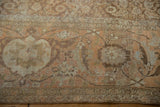 Detailed samovar and Herati motifs on the low-pile, sand-toned border of a vintage rug.