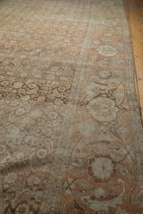 The worn texture of the Herati-patterned field meeting the wide, sandalwood-toned samovar border.
