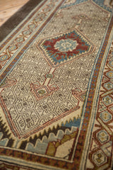 Close-up of the Serab runner's intricate geometric lattice with distressed ivory, blue, and gold tones.