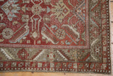 Corner view of distressed vintage Heriz runner, worn brick red Herati motif, exposed foundation.