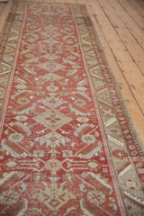 Vintage Distressed Heriz runner with faded Herati motifs and warm brick red tones.