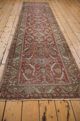Heriz runner end with secured fringe and worn brick red and olive Herati design.