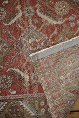 Distressed Heriz runner, brick red Herati motif pile, exposed foundation, and woven back.