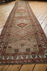 Decorative distressed Northwest Persian runner detail: geometric patterns, madder red, and muted silver.