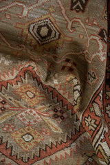 Time-softened texture on vintage Northwest Persian runner, with madder red serrated contours and abrash.