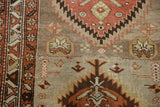 Distressed vintage Northwest Persian runner with abrashed field, madder red and ivory geometric patterns.