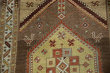 Pale saffron geometric patterns and stylized rams horn buds on a distressed Persian runner.