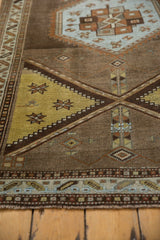 Distressed Northwest Persian rug texture with powder blue, saffron, and chestnut brown details.