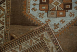 Distressed Northwest Persian runner's corner, powder blue, chestnut geometric motifs, and side selvage.