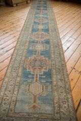 Distressed Serab runner showing geometric floral motifs, abrashed denim blue, and patterned vine border.