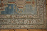 Vintage distressed Serab rug corner, showcasing abrash, geometric motifs, and intact selvage.