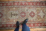 Overhead view of the distressed Karaja runner with red geometric medallions and playful pinwheels.