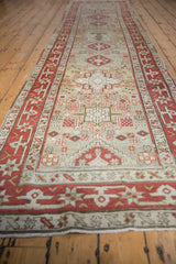 Angled view down the length of a distressed Karaja runner, highlighting its geometric pattern.