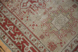 Close-up of the distressed, low-pile weave and geometric starburst motifs in madder red.