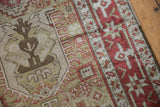 Close-up of the low-pile weave showing a Tree of Life motif and geometric borders in red, sage, and brown.
