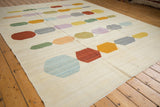 Afghani Kilim rug with abstract pebble design in multi-hued pastel tones and abrashes.