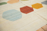 Textured Afghani Kilim showing abstract pebble elements with ivory ground and abrashes.